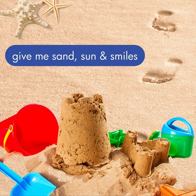Give me sand, sun, and smiles text with a sand castle