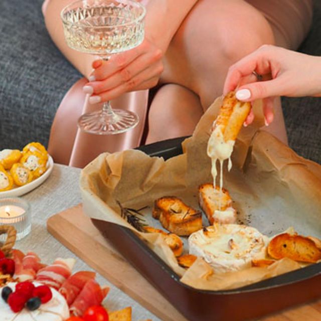 Crispy bread being dipped in a creamy dip